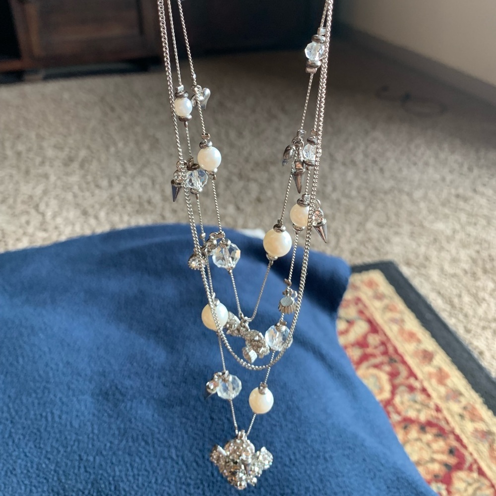 It’s three layer silver necklace with diamonds